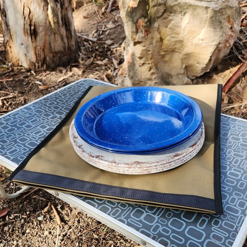 Camping plates on top of canvas storage bag