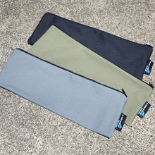 Load image into Gallery viewer, Three rectangular pouches in black, green, and gray on a textured surface