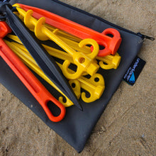 Load image into Gallery viewer, Grey canvas bag with assortment of coloured sand pegs