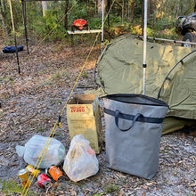 Load image into Gallery viewer, Camping scene with a tent, trash bags, and a rubbish in a forest setting.