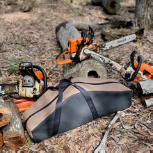 Load image into Gallery viewer, Stihll Chainsaws on logs with a carrying case in a forest setting