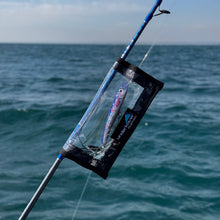 Load image into Gallery viewer, Fishing lure in a clear container with ocean in the background