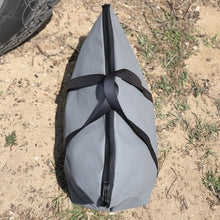 Load image into Gallery viewer, Gray bag with a black strap and zipper on a sandy ground