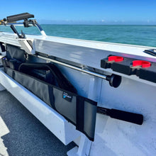 Load image into Gallery viewer, A close-up of a black fishing rod holder and rod mounted on the side of a white boat deck