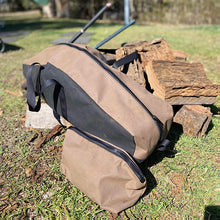 Load image into Gallery viewer, Chainsaw bag next to a pile of cut wood