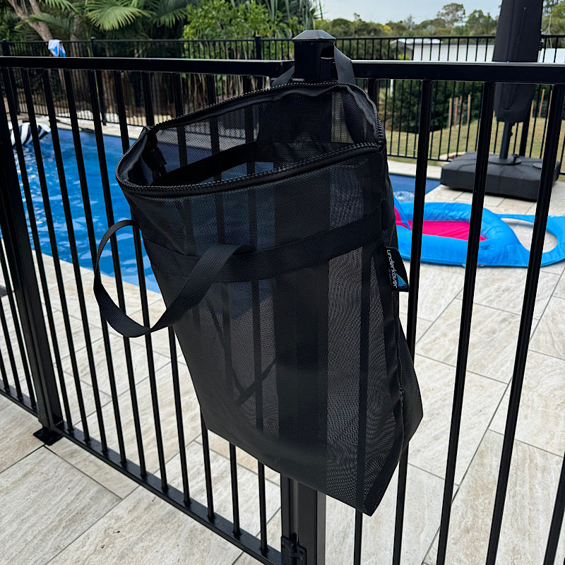 Mesh drainage bag hanging on pool fence 