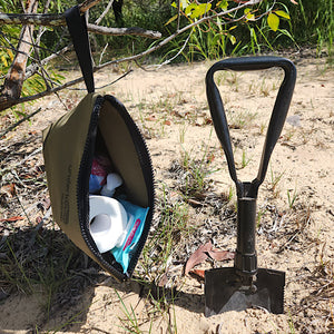 toilet paper inside canvas bag hanging from tree