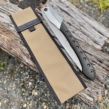 Load image into Gallery viewer, Folding knife with black handle and silver blade on a brown sheath, placed on a wooden log.