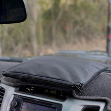 Load image into Gallery viewer, Black zippered dash bag on a vehicles dashboard