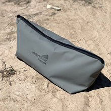 Load image into Gallery viewer, Canvas bag zipped up sitting on sand