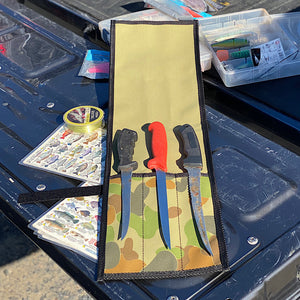 Knife roll with 3 knives sitting on top