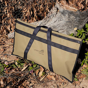 canvas bag sitting against tree