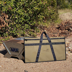 fire pit and storage bag next to a bush