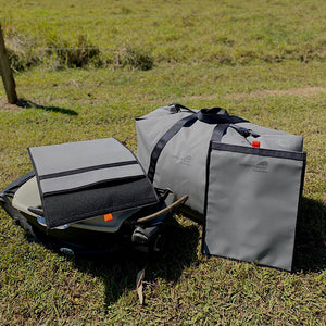 weber bbq and storage bags on grass